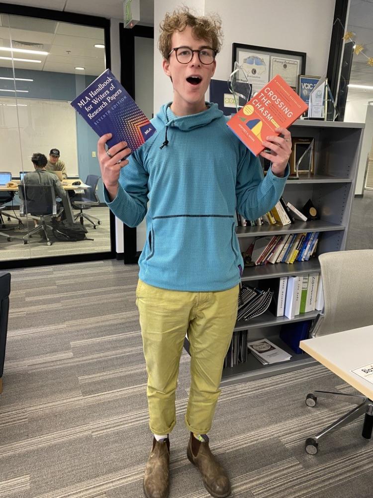 Jayden Kazantsev holding books