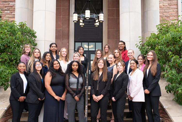 Participants in the 2023 Leeds Women in Business Case Competition pose in front of the Koelbel Building. 