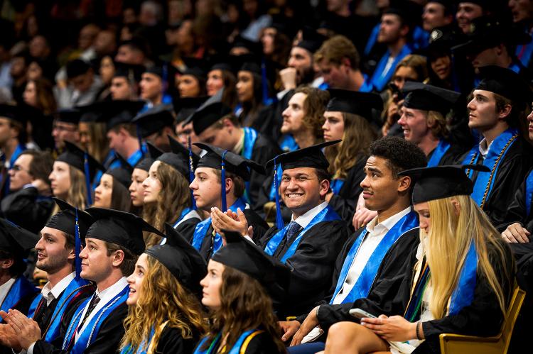 Leeds graduates sit at the CU Events Center during graduation.