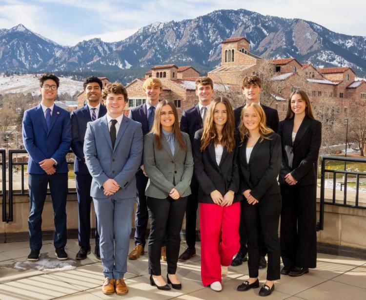 CU Real Estate Club members pose in front of the Flatirons
