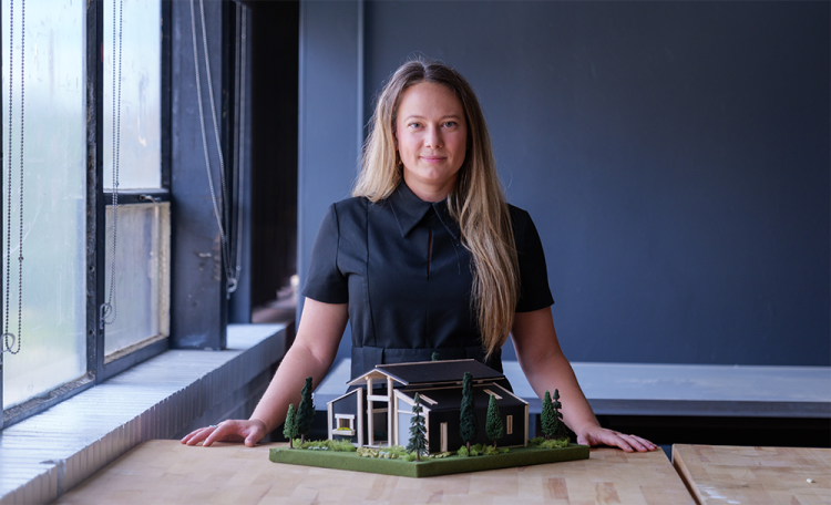Jamie Saunders holding a model from her affordable-homes venture AFFIX Communities