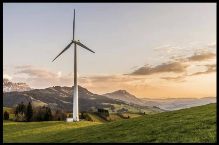 Wind Turbine in a Field with Mountains in the Background