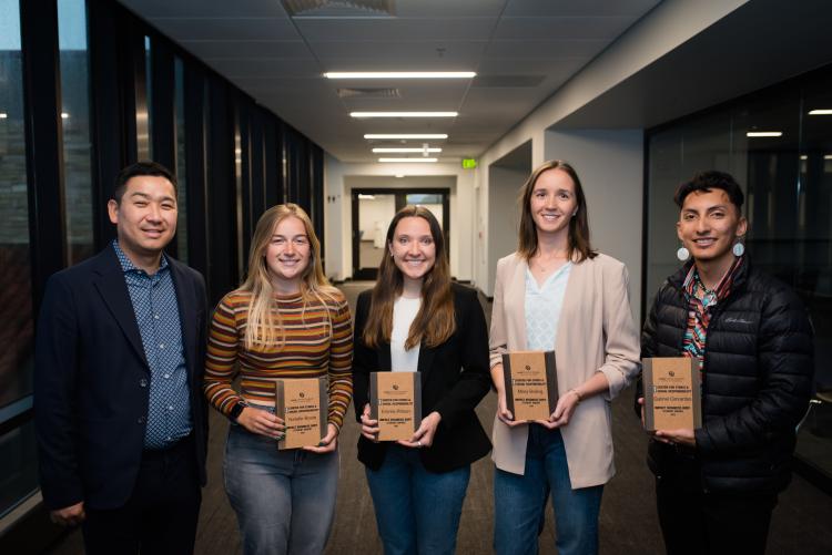 Winners of the 2024 Impact Business Buff Awards pose with their awards