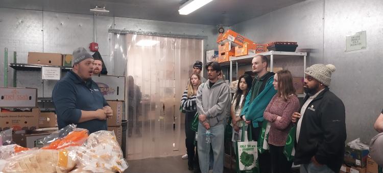 Luke Archebeque talking with students at Sprouts
