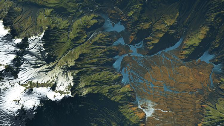 Graphic image of rippling water showing green, white, and blue