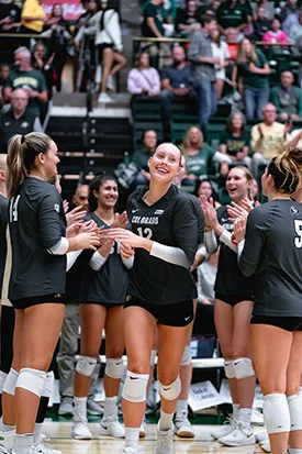 Taylor Simpson celebrates with teammates during a CU Volleyball game
