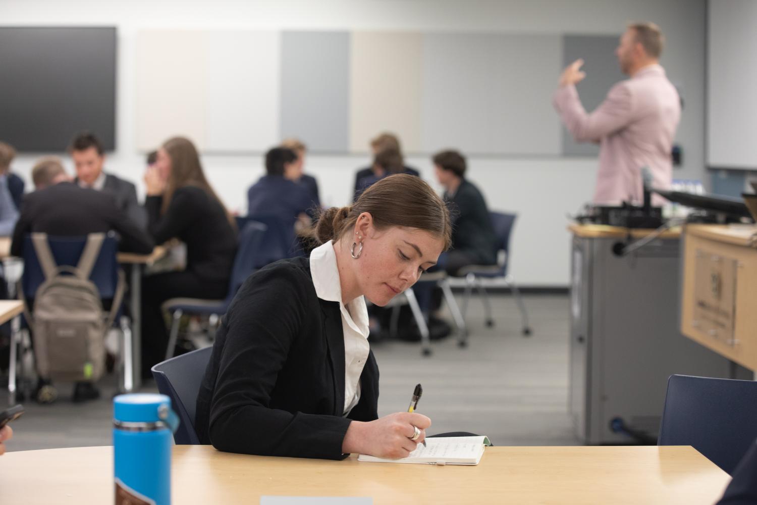 Student taking notes at LPS 2025
