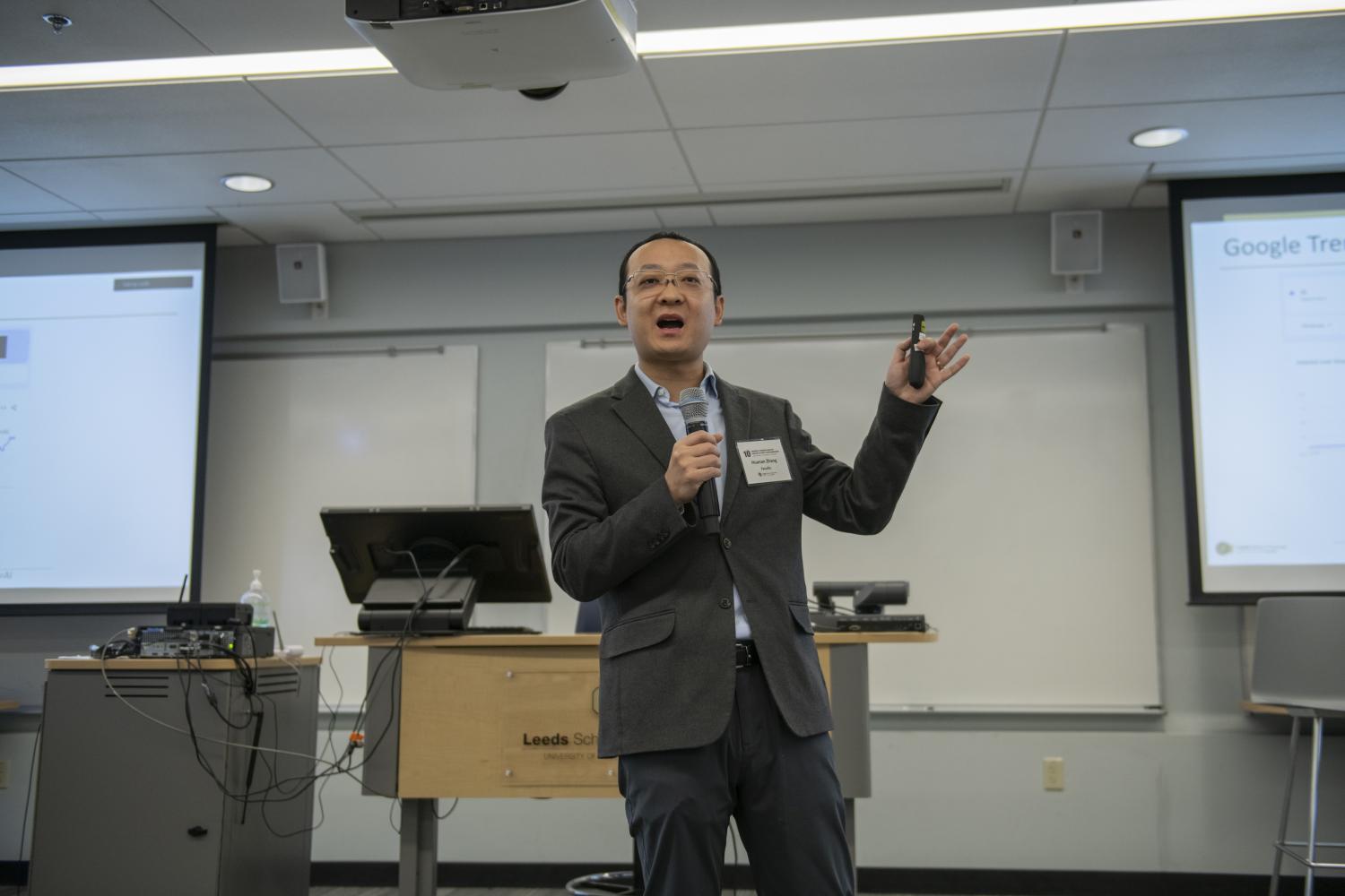 Hunang Zhang speaks into a mic