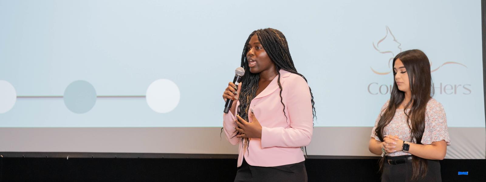 Girl presenting at women in business case competition 