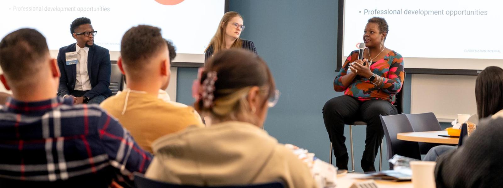 KeyBank staff members are speaking at a Lunch & Learn event as part of the Business at a Glance program, actively engaging with the audience