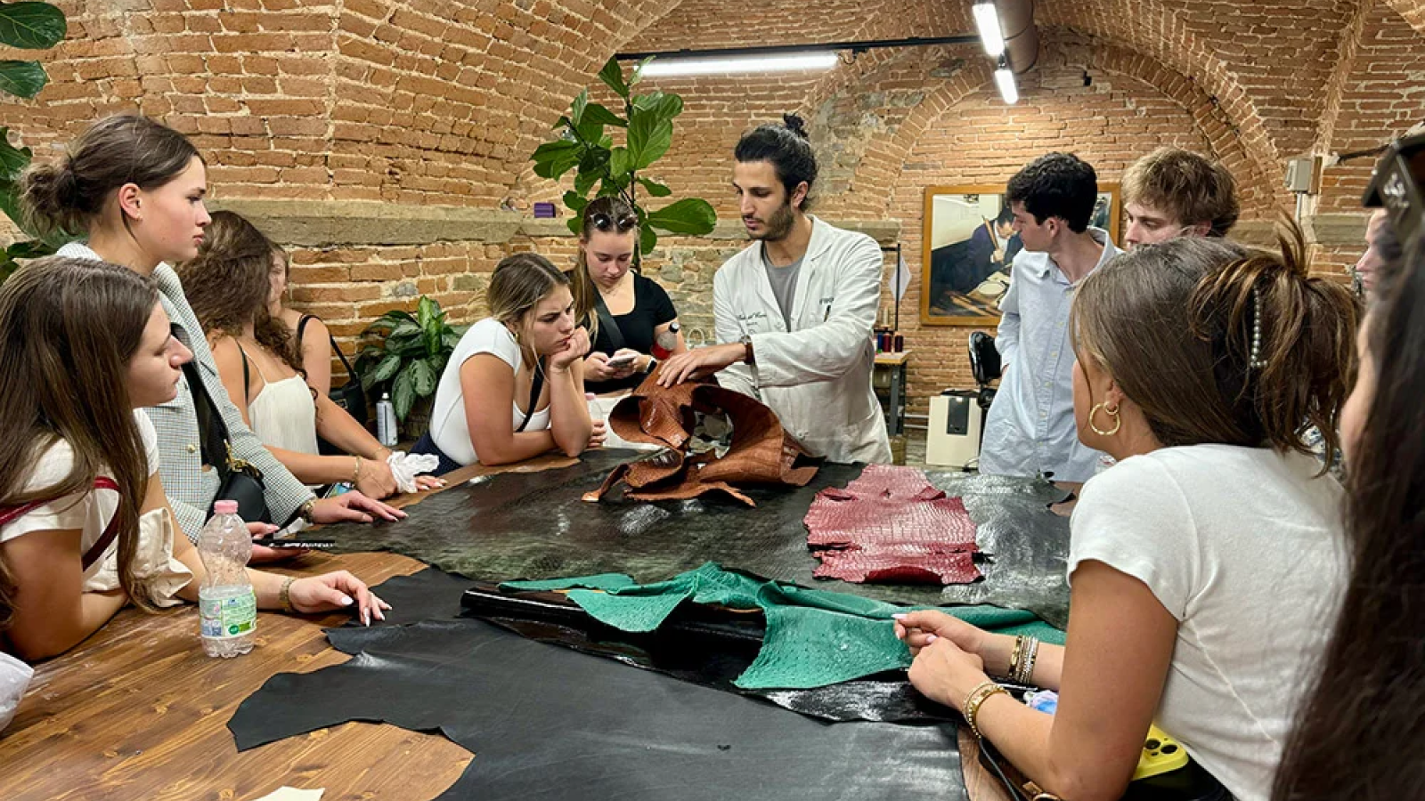 Students listen to a presenter during a company visit on an FGX trip.