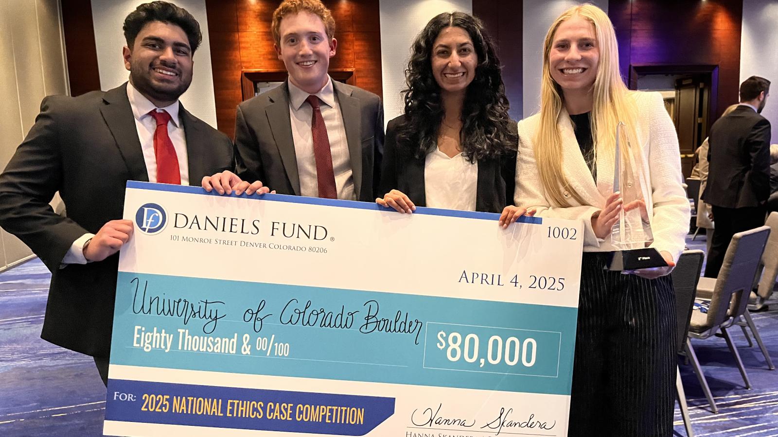 Daniels Fund Case Competition winners pose with a check