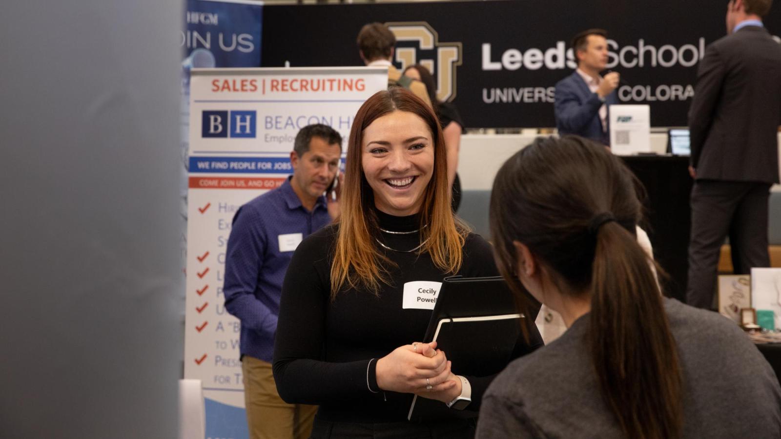 A student speaks with a recruiter during one of Leeds' industry fairs.
