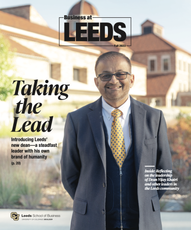 Cover of the 2023 Business at Leeds Magazine, which features Dean Vijay Khatri smiling with the Koelbel Building in the background.