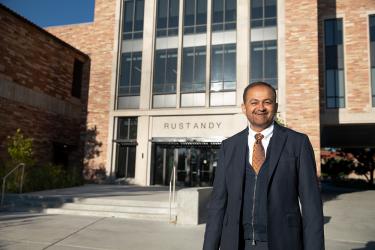 Dean Vijay Khatri poses outside of the Rustandy Building