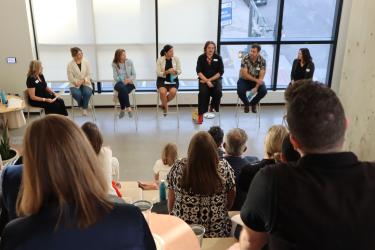 Panel of sustainability professionals talking to a group