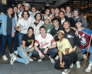 A large group of young people pose for a photo