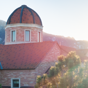 Image of the dome atop the Koelbel building housing Leeds during sunset