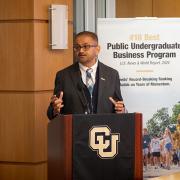 Dean Vijay Khatri speaks from a podium during Leeds Media Day.