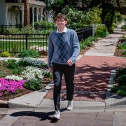 Carter Snelson smiles while he walks across a Boulder street.