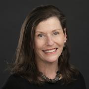 Portrait of Sheila Duffy against a dark background