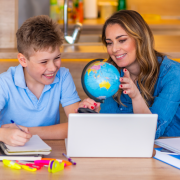 Image of woman and a child look at a globe