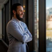 Fawad Ahmadzai chuckles while gazing out a window in the Rustandy Building.