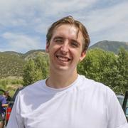 Connor Lacey at an outdoor event. The mountains are visible in the background.