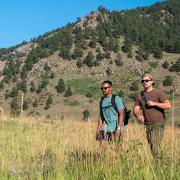 Two veterans hiking in Chautauqua park. The foothills of the Rocky Mountains can be seen in the back.