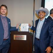 Nick Brown and Uriel Berrum holding their Dolphin Tank award