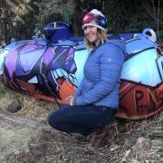 Liz Compos in front of one of her murals