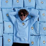 Rylan Montoya Laying in a pile of DumbClub Sweatshirts