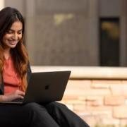 student working outside on laptop