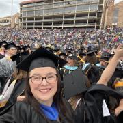 Emily Speer Ryan at her CU Boulder graduation surrounded by other graduates