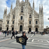 Anna holding a CU Boulder flag at Duomo in Milan, Italy