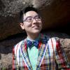Z Yang wearing a bow tie standing in front of the flatirons.