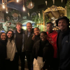 A group poses for a photo at night
