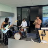 A trio plays instruments