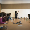 People sit around a table in a professional setting