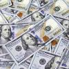 100 dollar bills spread out on a surface