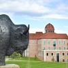Buffalo statue in the foreground; Koelbel Building in the background