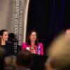 Panelists present to a packed audience at the outlook event.