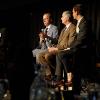 A group of four professionals onstage.