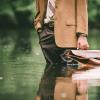 A businessman stands up to his calves in water.