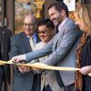 Five people in professional dress cut the ribbon on a new building on the CU Boulder campus.