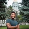 Eyob Abai smiles while standing outside the Colorado State Capitol.