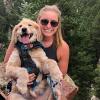 Amber Hughes on a forest hiking trail with her puppy.