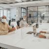 Business meeting with masked participants