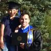 Harrison GreenMaki at graduation. A small boy is wearing his mortarboard.