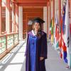 Jessica Yan poses in regalia during her master's program graduation.